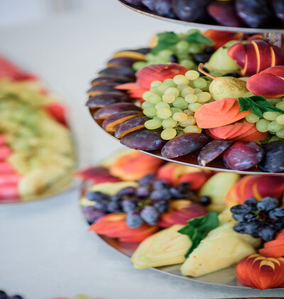 Sliced peaches, apples, ananas and plums served on tired steel d